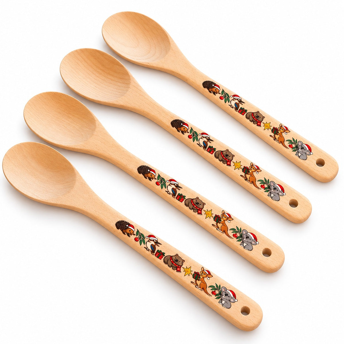 Four wooden spoons with festive Australian animal designs on their handles against a white background.