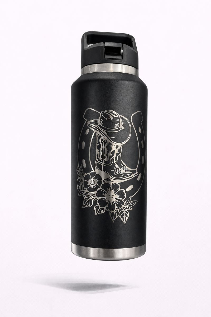 Black bottle engraved with a cowboy hat, boots, horseshoe and floral accents.