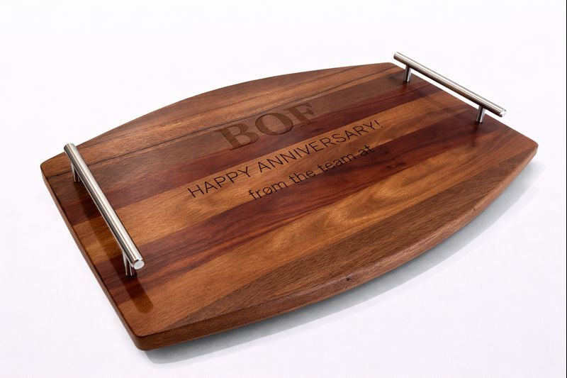 Wooden serving tray with metal handles engraved with a personalised anniversary message.