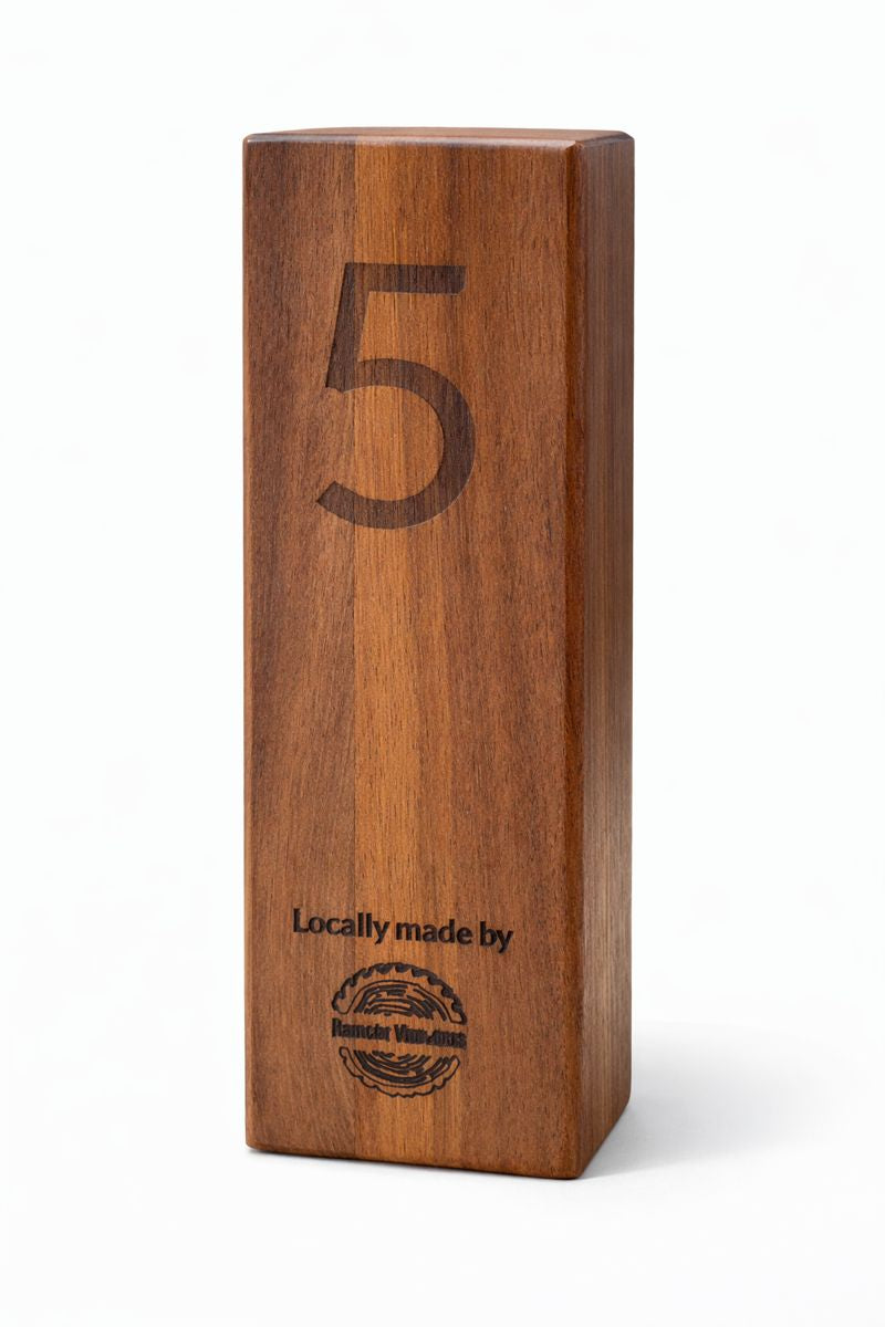 Laser‑engraved wooden milestone block displaying the number 5.