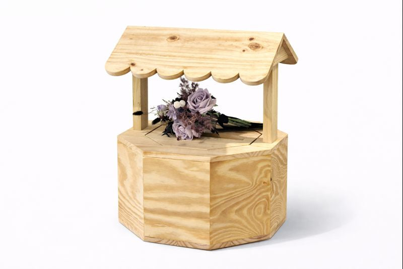 Mini wooden wishing‑well planter with scalloped roof.