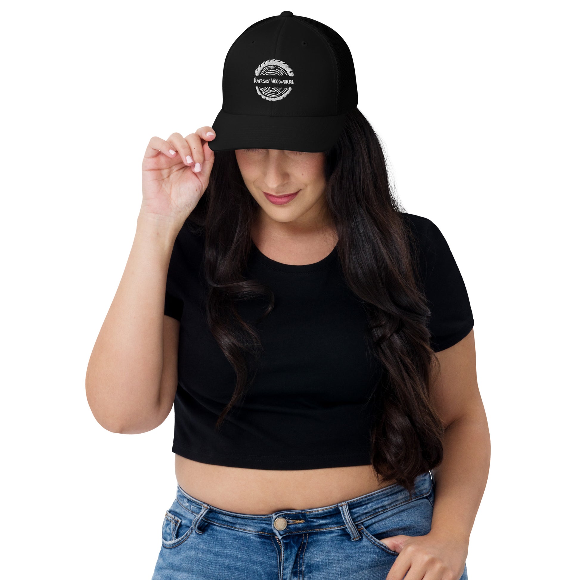 Side view of black trucker cap with white logo and breathable mesh back