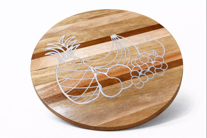 Round wooden serving board engraved with a pineapple and grapes outline.