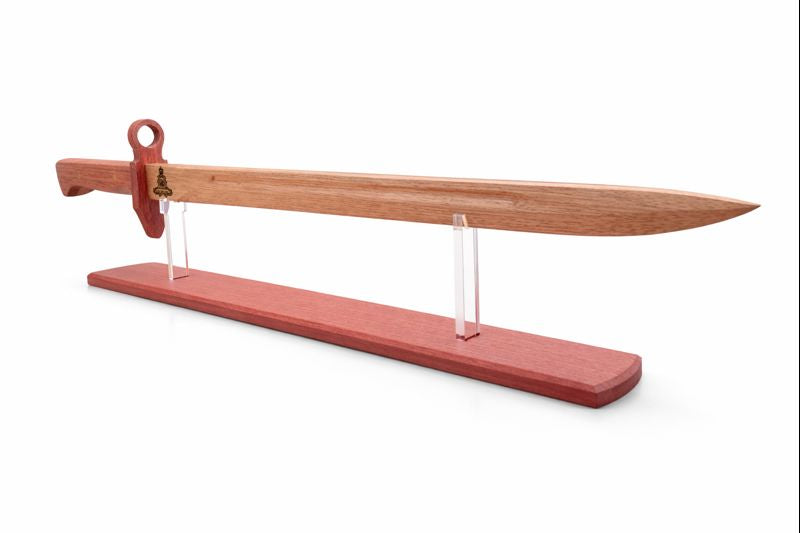 Hand‑crafted wooden ceremonial sword or paddle displayed on a stand.
