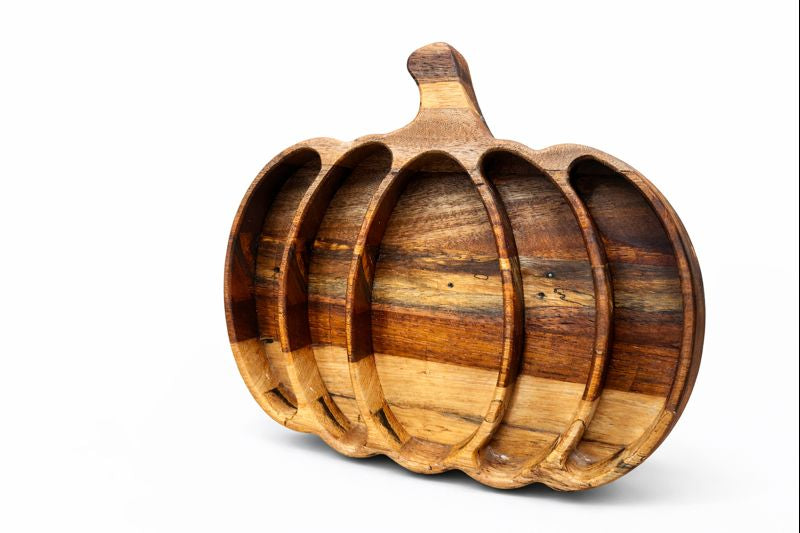 Pumpkin‑shaped wooden platter with multiple sections for serving snacks.