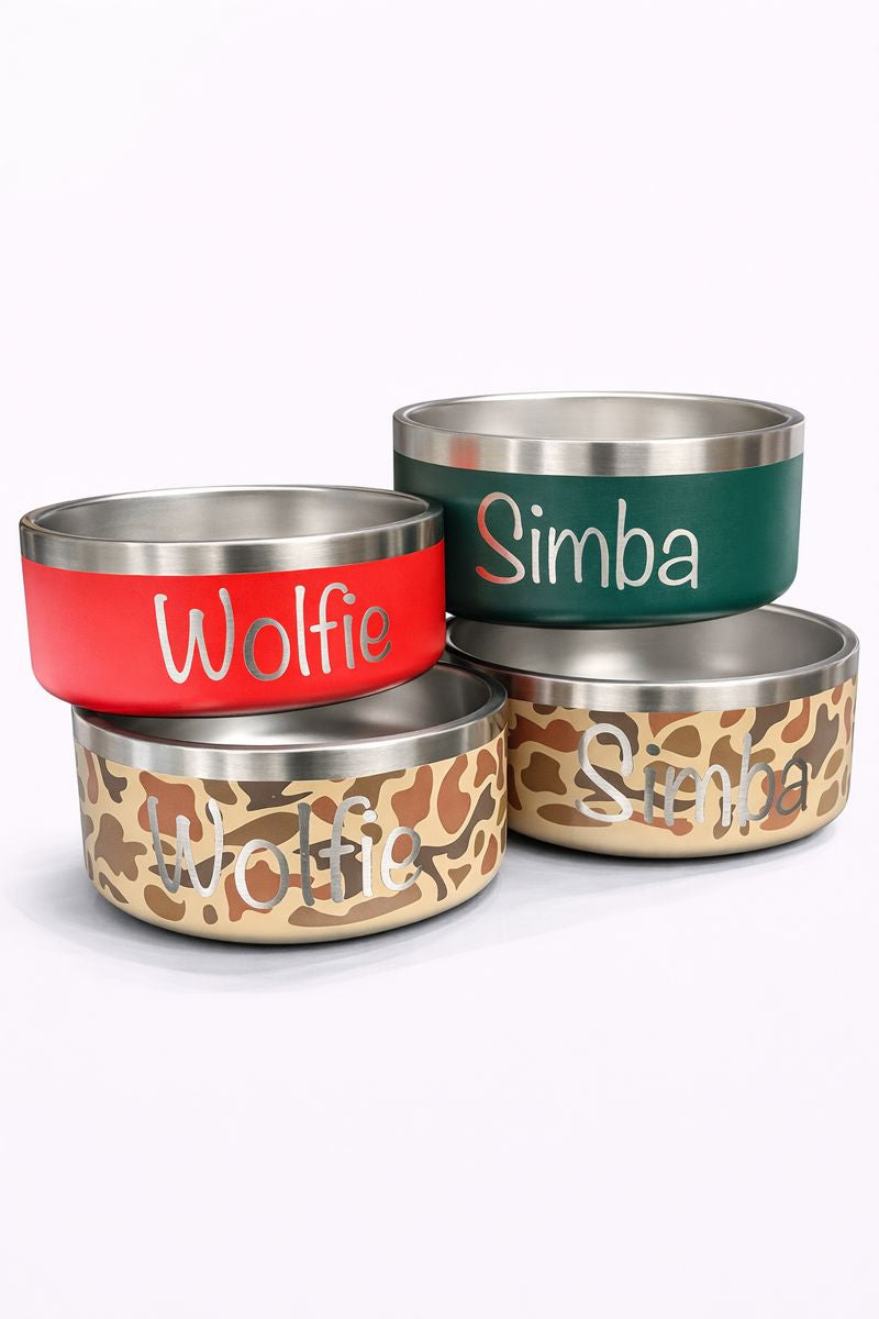 Stack of YETI dog bowls in red, green and camouflage finishes with names Wolfie and Simba